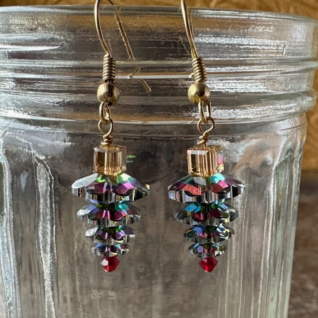 Swarovski crystal, upside-down, Christmas tree earrings at Suzie Q Studio, variegated green, with red tree topper bead and gold-tone ear wires.