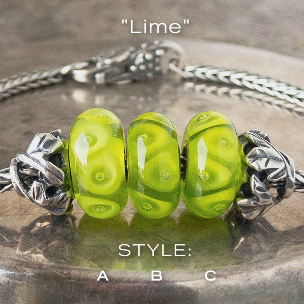 Three versions of glass LIME Trollbead, triangle & bubble design, in tones of bright green, on Trollbeads silver bracelet.