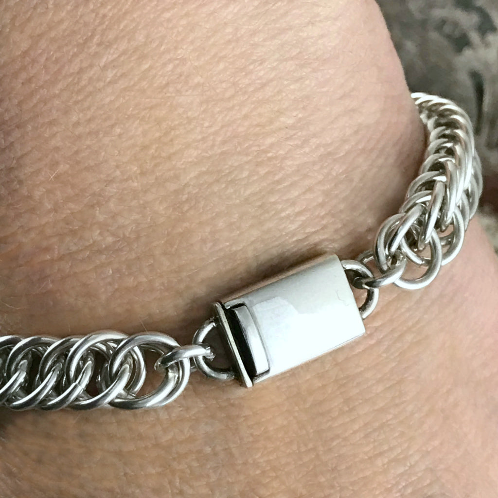 This Suzie Q Studio handmade sterling silver chain bracelet is perfect for both guys and gals, with its sleek look and secure box-style clasp. Substantial, 16 gauge sterling silver jump rings were woven together to create this Half Persian chain that’ll wrap lusciously around your wrist.