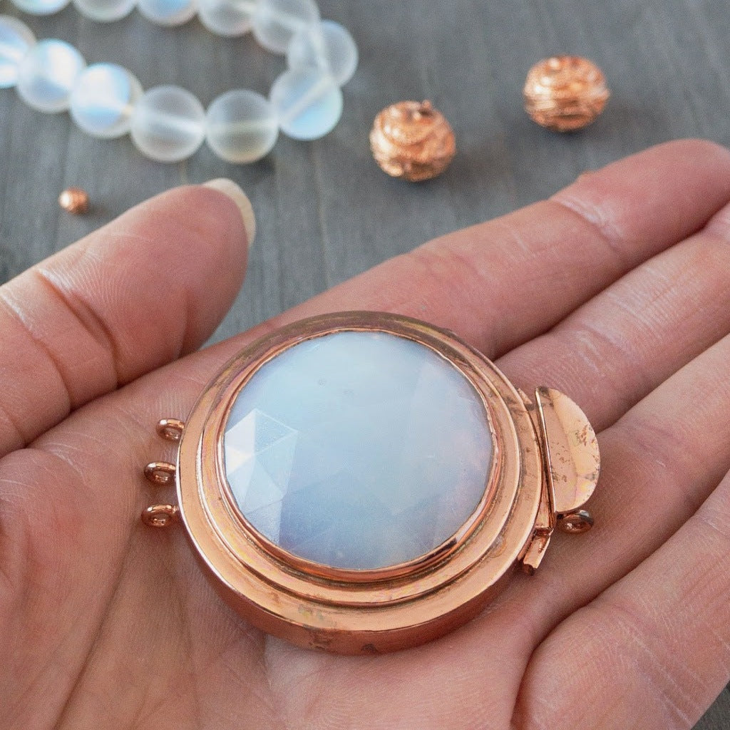 The iridescent glow of the "white opal" effect of this vintage glass cabochon, featured in this box clasp, is simply stunning! It was individually handcrafted in 100% pure copper, exclusively for Suzie Q Studio and would be perfect as a focal of a multi-strand, "Breakfast at Tiffany's"-style, choker necklace.
