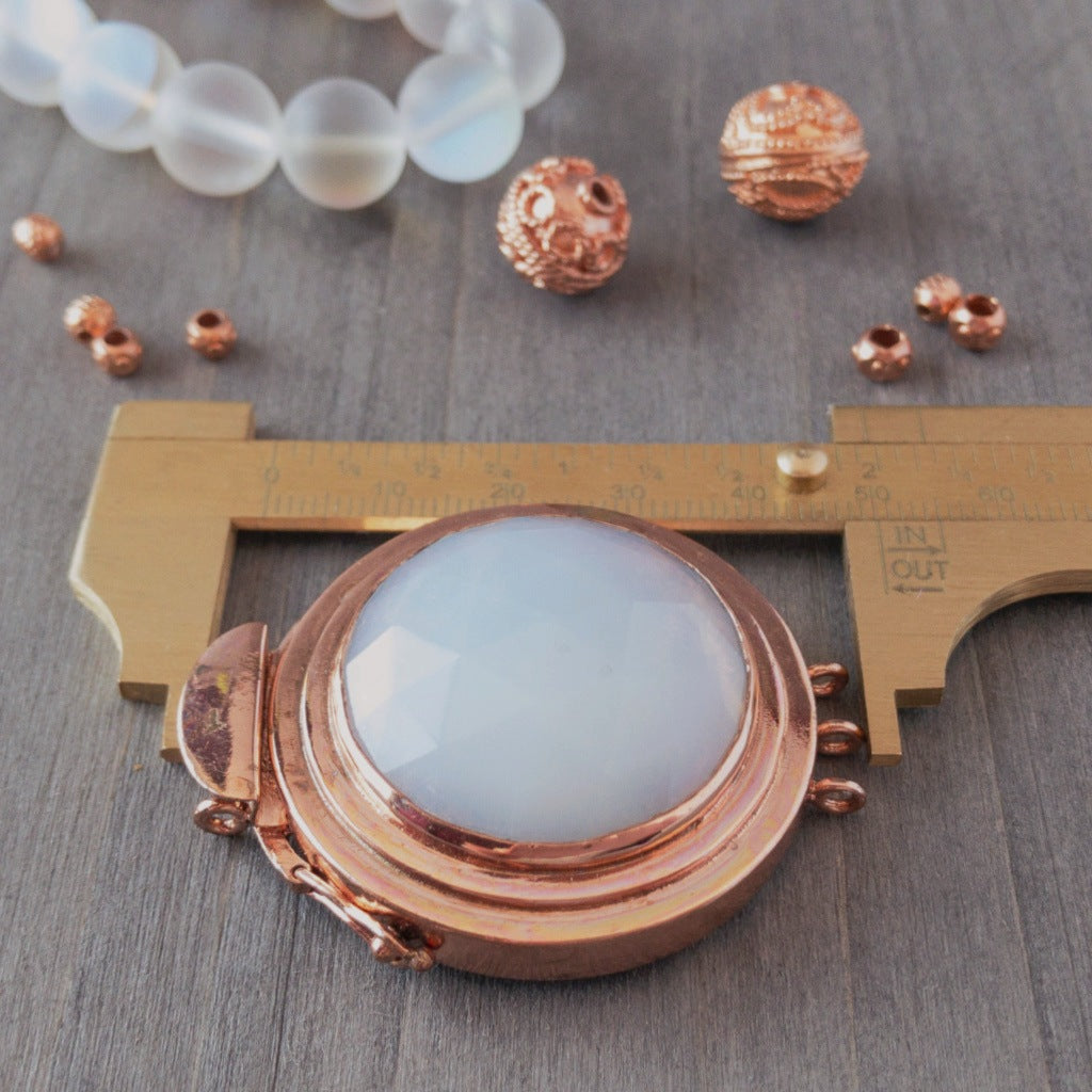 The iridescent glow of the "white opal" effect of this vintage glass cabochon, featured in this box clasp, is simply stunning! It was individually handcrafted in 100% pure copper, exclusively for Suzie Q Studio and would be perfect as a focal of a multi-strand, "Breakfast at Tiffany's"-style, choker necklace.