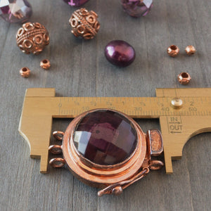 This unique box clasp showcases a warm, amethyst-coloured, vintage, faceted glass cabochon, and is surrounded by copper that has a beautiful natural, antique patina finish. It was individually handcrafted in 100% pure copper, exclusively for Suzie Q Studio.