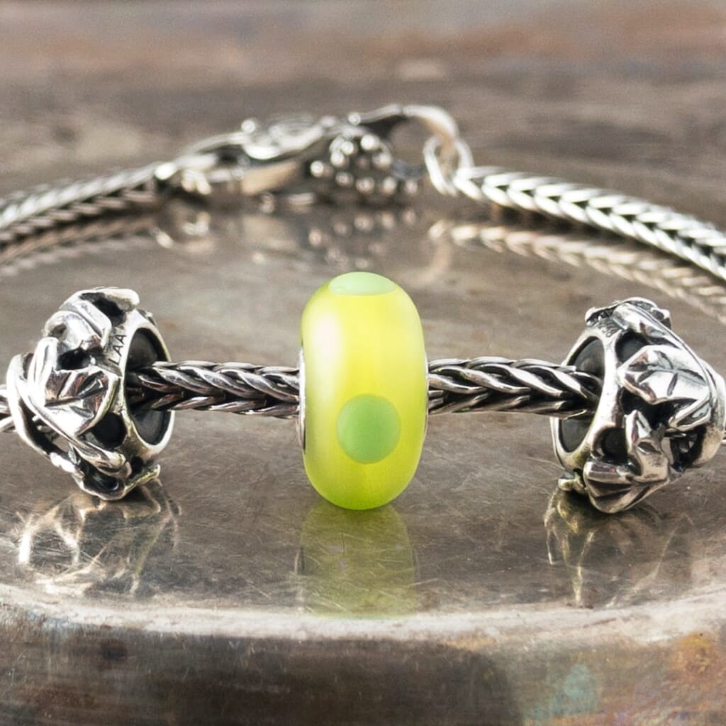 The sandblasted surface of Suzie Q Studio's Green Sand Trollbead absorbs and softens the light in this brightly-coloured bead giving it a luscious inner glow. Visit Suzie Q Studio for new stock, never worn, collectible Rare & Retired Trollbeads.