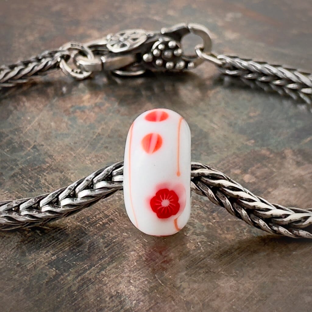 Suzie Q Studio’s Trollbeads UME – Red Plum Blossom on White – glass bead in the KIMONO Collection that was created in the delicate matte colours of a Japanese kimono.