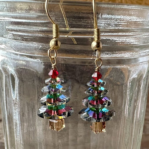 Sparkly Swarovski crystal Christmas tree earrings at Suzie Q Studio, variegated green in colour, with a red tree topper bead and gold-tone ear wires.