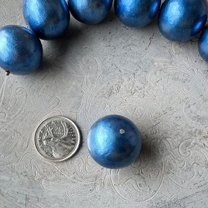 24mm Montana Blue cotton pearl bead with deep, pearlized shine and textured surface, shown next to a Canadian quarter for scale, and available from Suzie Q Studio.