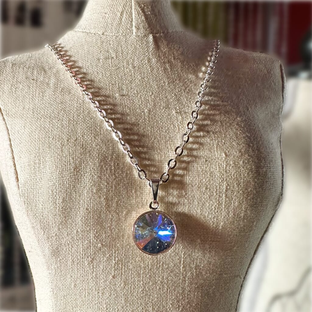 Swarovski crystal necklace, with round, "rivoli” stone pendant, with a crystal AB / Aurora Borealis finish, on a delicate, silver-plated chain.
