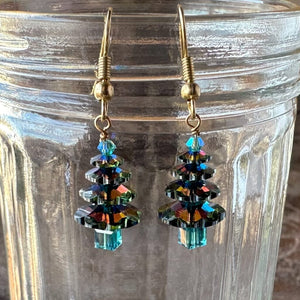 Swarovski crystal “Elvis Blue Christmas” tree earrings at Suzie Q Studio, in various tones of ocean blue, tree top to trunk, with gold-tone ear wires.
