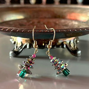 Sparkly Swarovski crystal Christmas tree earrings at Suzie Q Studio, variegated green, with fuchsia tree topper bead and gold-tone ear wires.