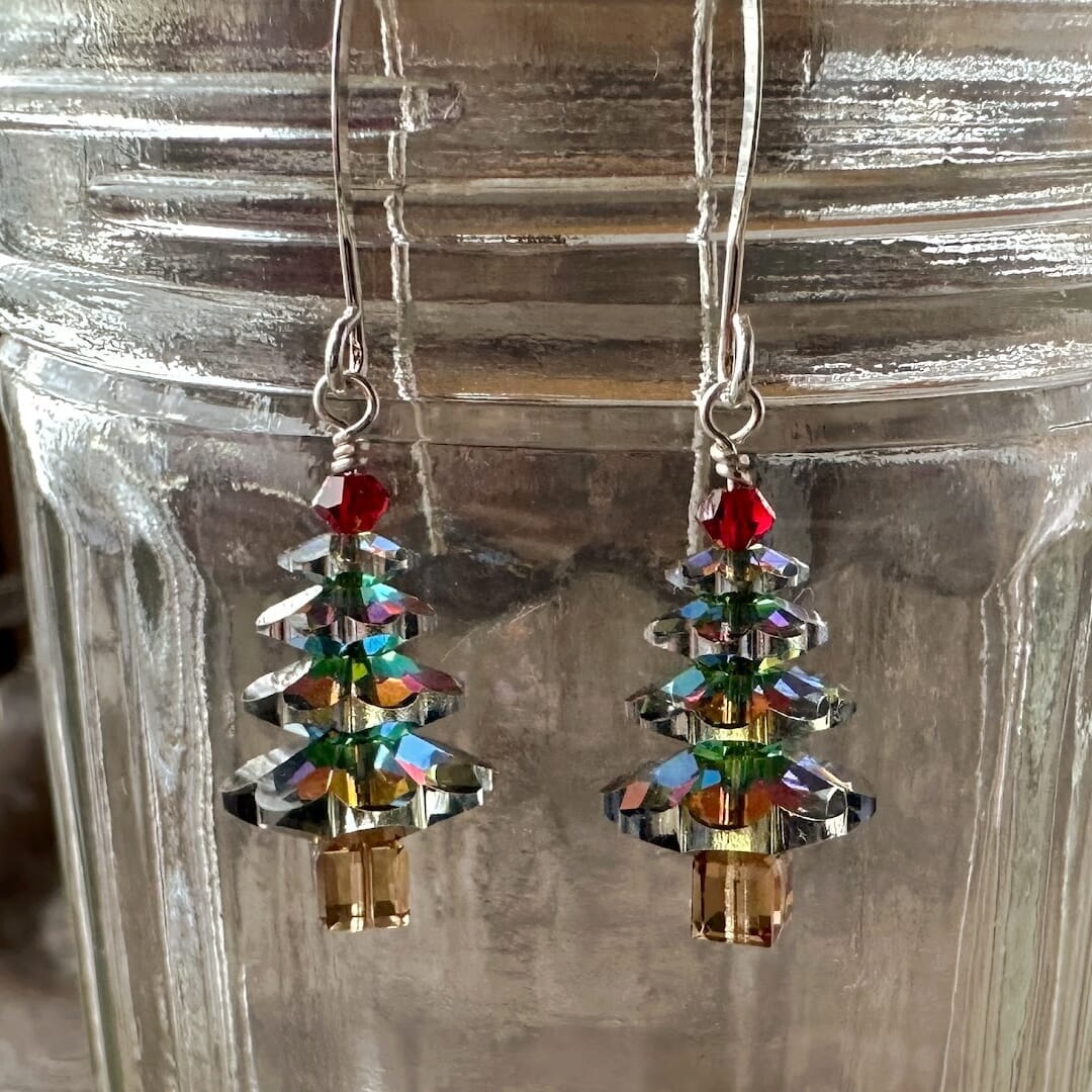 Sparkly Swarovski crystal Christmas tree earrings at Suzie Q Studio, variegated green in colour, with a red tree topper bead and silver plate ear wires.