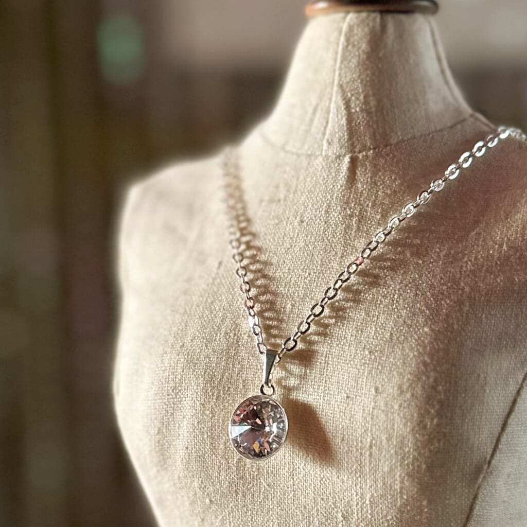 Swarovski crystal necklace, with round, "rivoli” stone pendant, with a crystal FB / "foil back" finish, on a delicate, silver-plated chain.