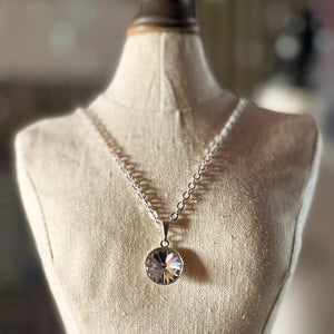 Swarovski crystal necklace, with round, "rivoli” stone pendant, with a crystal FB / "foil back" finish, on a delicate, silver-plated chain.