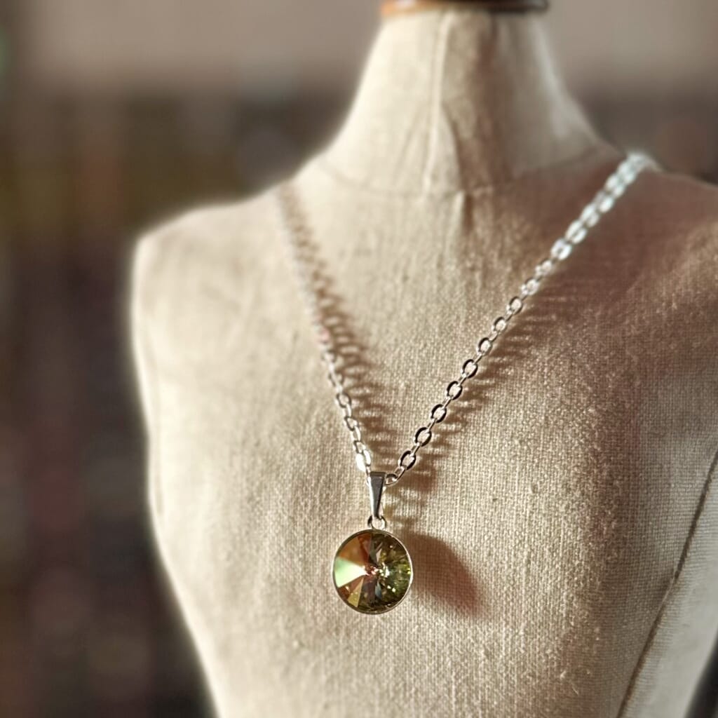 Swarovski crystal necklace, with round, "rivoli” stone pendant, with a crystal "Sahara"  green finish, on a delicate, silver-plated chain.