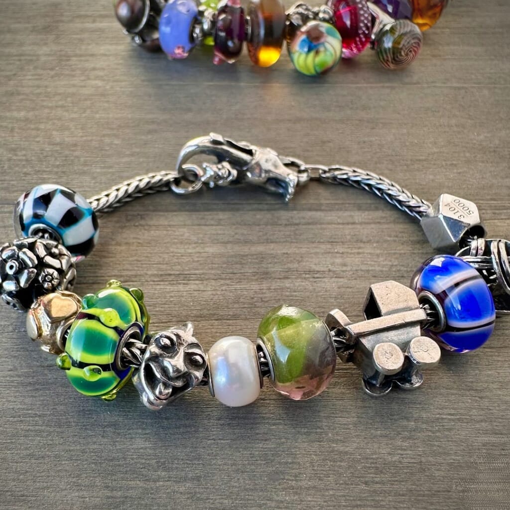 Trollbeads 30th Anniversary, blue, black and white glass bead called, TROLL SHADES, originally released in 2006, shown on a sterling silver bracelet, with lock. Shop online for one-of-a-kind treasures at Suzie Q Studio.
