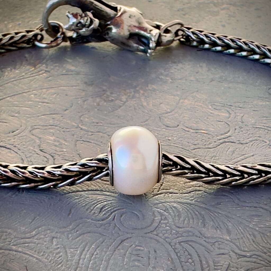 Freshwater pearl bead called, WHITE PEARL, which is still available in the Trollbeads Collection, and shown on a sterling bracelet, with lock.