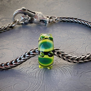LE Trollbeads 30th Anniversary, glass bead, in various tones of green called, CATERPILLAR, from 2006, shown on a sterling silver bracelet, with lock. Shop online for one-of-a-kind treasures at Suzie Q Studio.