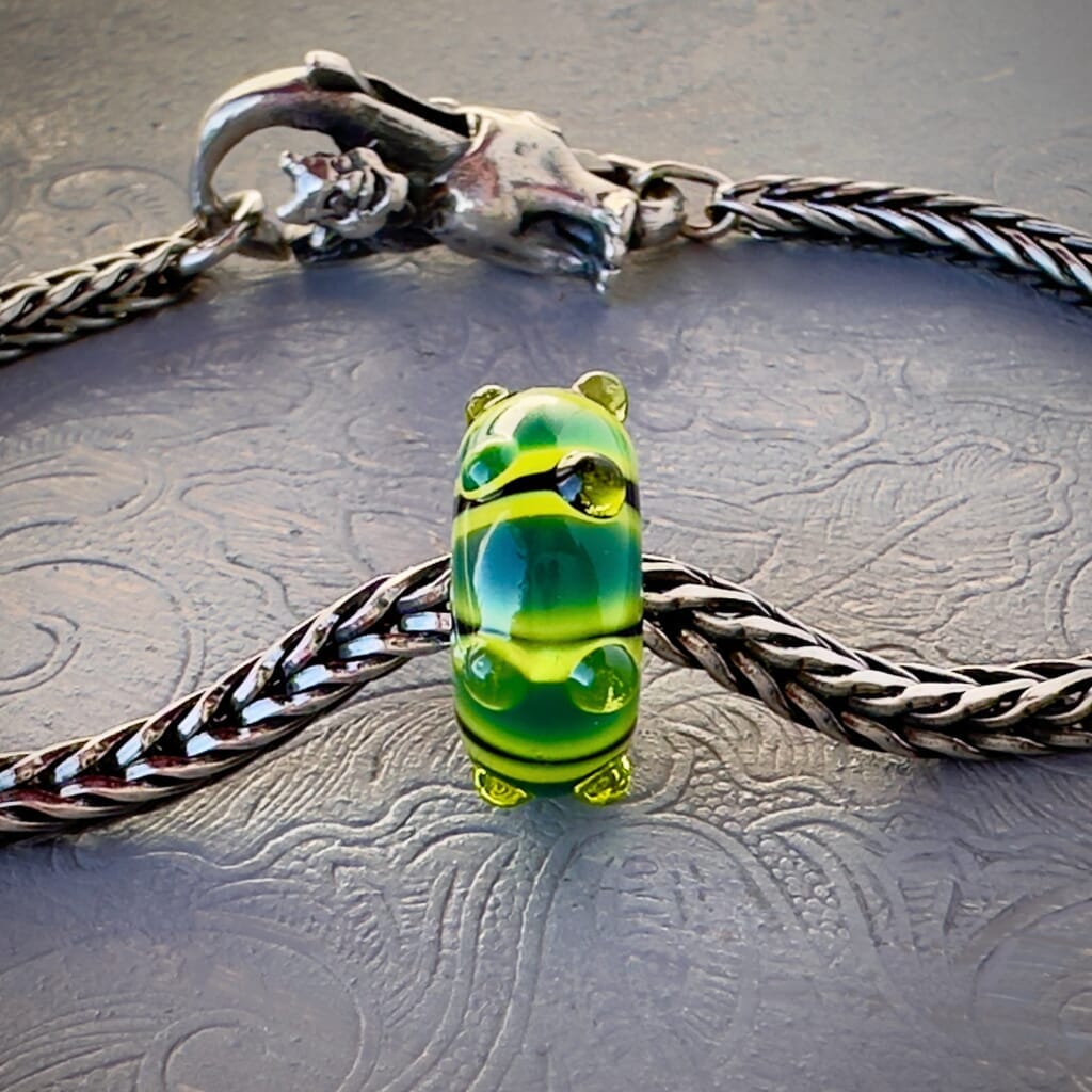 LE Trollbeads 30th Anniversary, glass bead, in various tones of green called, CATERPILLAR, from 2006, shown on a sterling silver bracelet, with lock. Shop online for one-of-a-kind treasures at Suzie Q Studio.