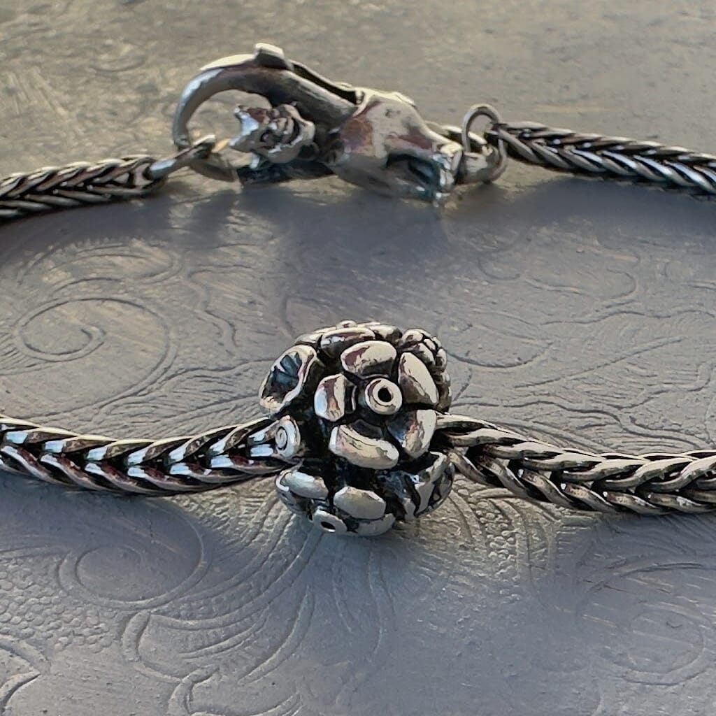 Trollbeads 30th Anniversary, sterling silver bead called, FLOWERS, originally released in 2006, shown on a sterling silver bracelet, with lock. Shop online for one-of-a-kind treasures at Suzie Q Studio.