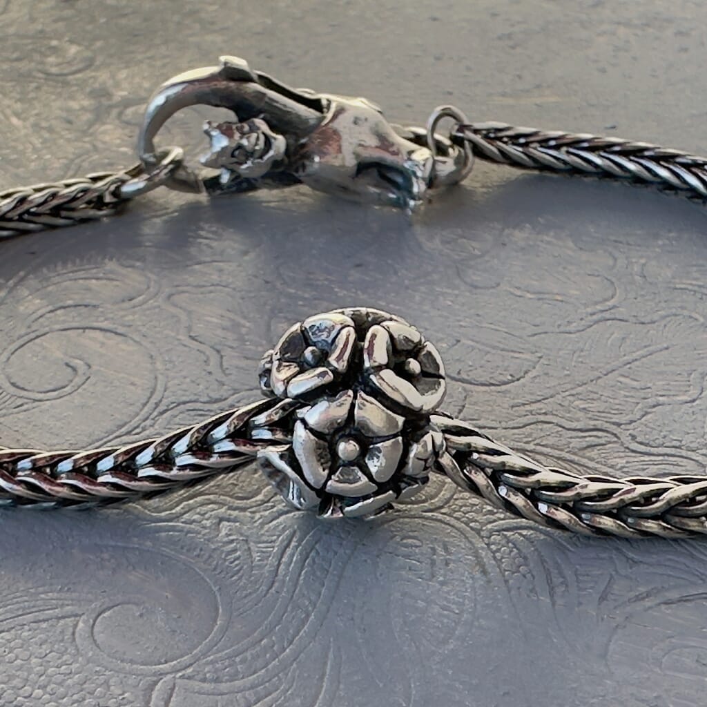 Trollbeads 30th Anniversary, sterling silver bead called, FLOWERS, originally released in 2006, shown on a sterling silver bracelet, with lock. Shop online for one-of-a-kind treasures at Suzie Q Studio.
