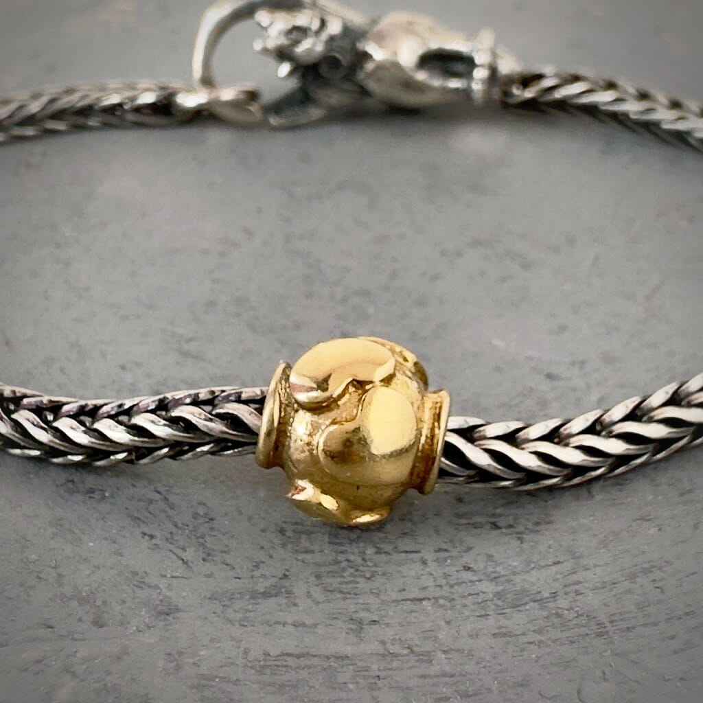 Trollbeads 30th Anniversary, 18KT gold bead called, HEARTBEATS, originally released in 2006, shown on a sterling silver bracelet, with lock. Shop online for one-of-a-kind treasures at Suzie Q Studio.