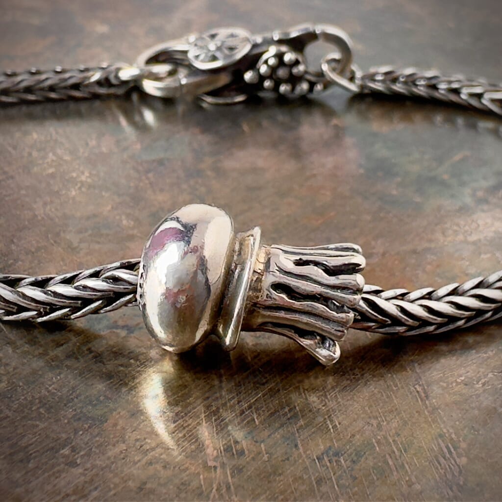Suzie Q Studio's Trollbeads sterling silver Jellyfish bead is inspired by the graceful jellyfish. Add a unique, aquatic charm to your bracelet. Shop now at Suzie Q Studio for your one-of-a-kind gifts!