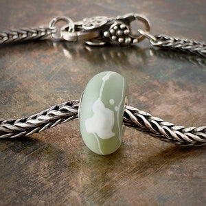 Suzie Q Studio’s Trollbeads Kimono "Tsuru" Bead – White Bird on Khaki/Green/Grey – symbolizes good luck and long life, fidelity and peace. Shop online for one-of-a-kind treasures at Suzie Q Studio.
