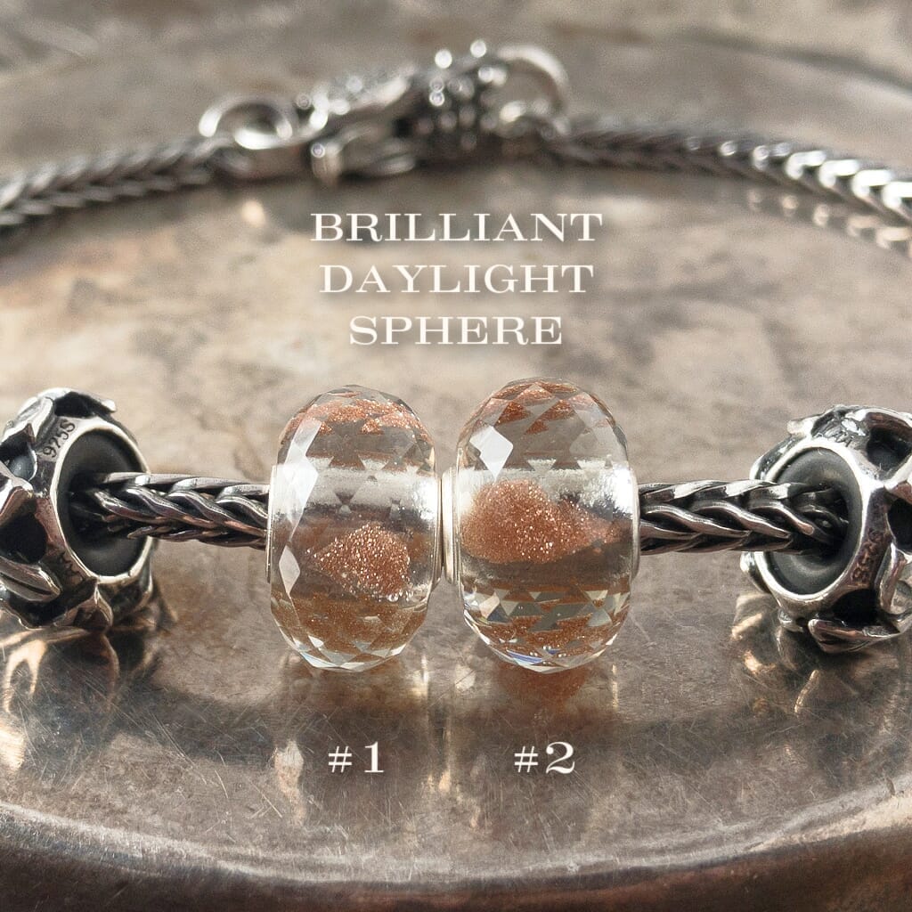 Suzie Q Studio's shimmering, faceted glass BRILLIANT DAYLIGHT SPHERE Faceted glass Trollbead is grey with sparkling copper inside. It reminds you to celebrate the daylight and stay warm when it's cold.  Visit Suzie Q Studio for new stock, never worn, collectible Rare & Retired Trollbeads.