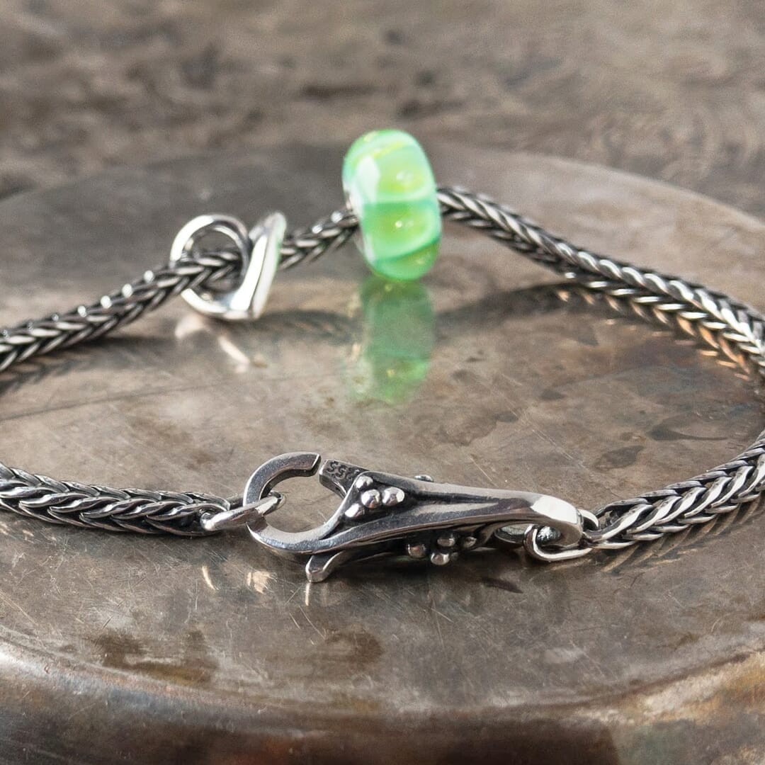 A gorgeous green glass bead with sparkling bubbles, an elegant, sterling silver heart bead and beautiful lock, all were never available individually in the Trollbeads Collection, and a classic Trollbeads foxtail-chain bracelet. Visit Suzie Q Studio for new stock, never worn, collectible Rare & Retired Trollbeads.