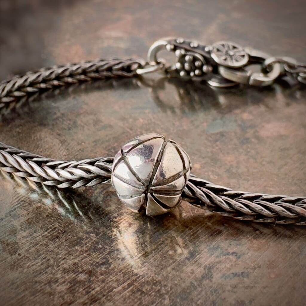 Suzie Q Studio’s Trollbeads sterling silver PETANQUE bead represents the classic "boule", or ball, from the popular French game, Pétanque and shown on a sterling bracelet with lock. Shop online for one-of-a-kind treasures at Suzie Q Studio.