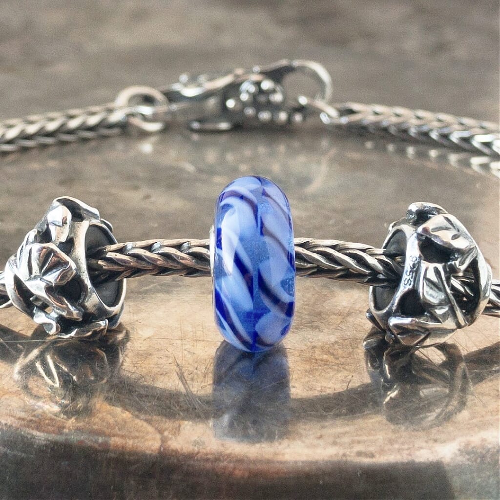 Suzie Q Studio has a treasure vault full of Rare & Retired Trollbeads... and we’re making them available to you. We’re starting with our Rare & Retired Glass Beads. Dark and light-blue braids come together into a joyful ribbon in this rare Trollbead.
