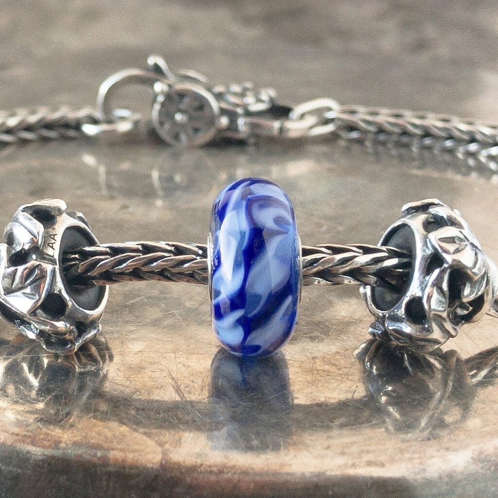 Suzie Q Studio has a treasure vault full of Rare & Retired Trollbeads... and we’re making them available to you. We’re starting with our Rare & Retired Glass Beads. Dark and light-blue braids come together into a joyful ribbon in this rare Trollbead.  