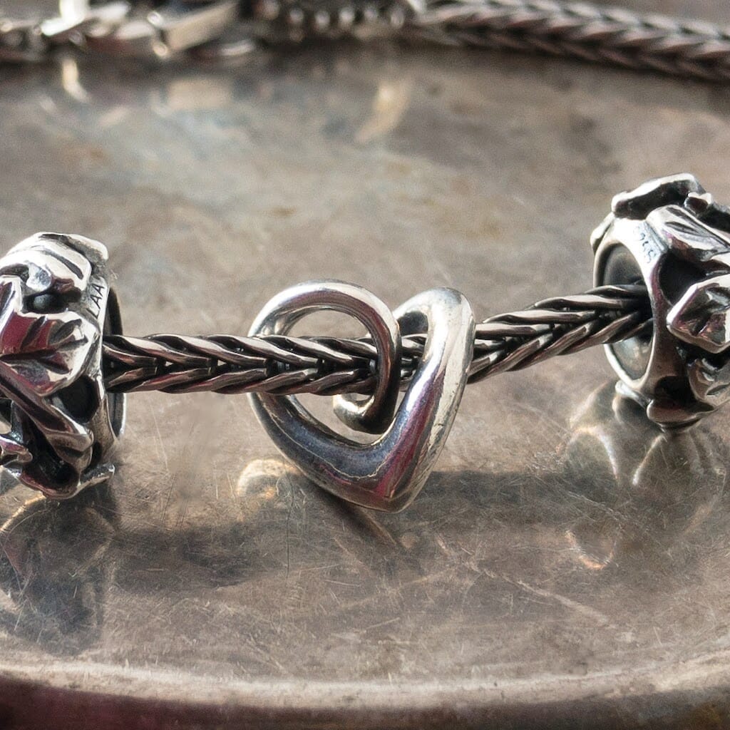 This sterling silver MY SWEET STORIES HEART Trollbead is ​​Sophisticated and elegant. Because it was never released by itself or available in the regular Trollbeads Collection, this is your chance to add it to your collection! Visit Suzie Q Studio for new stock, never worn, collectible Rare & Retired Trollbeads.