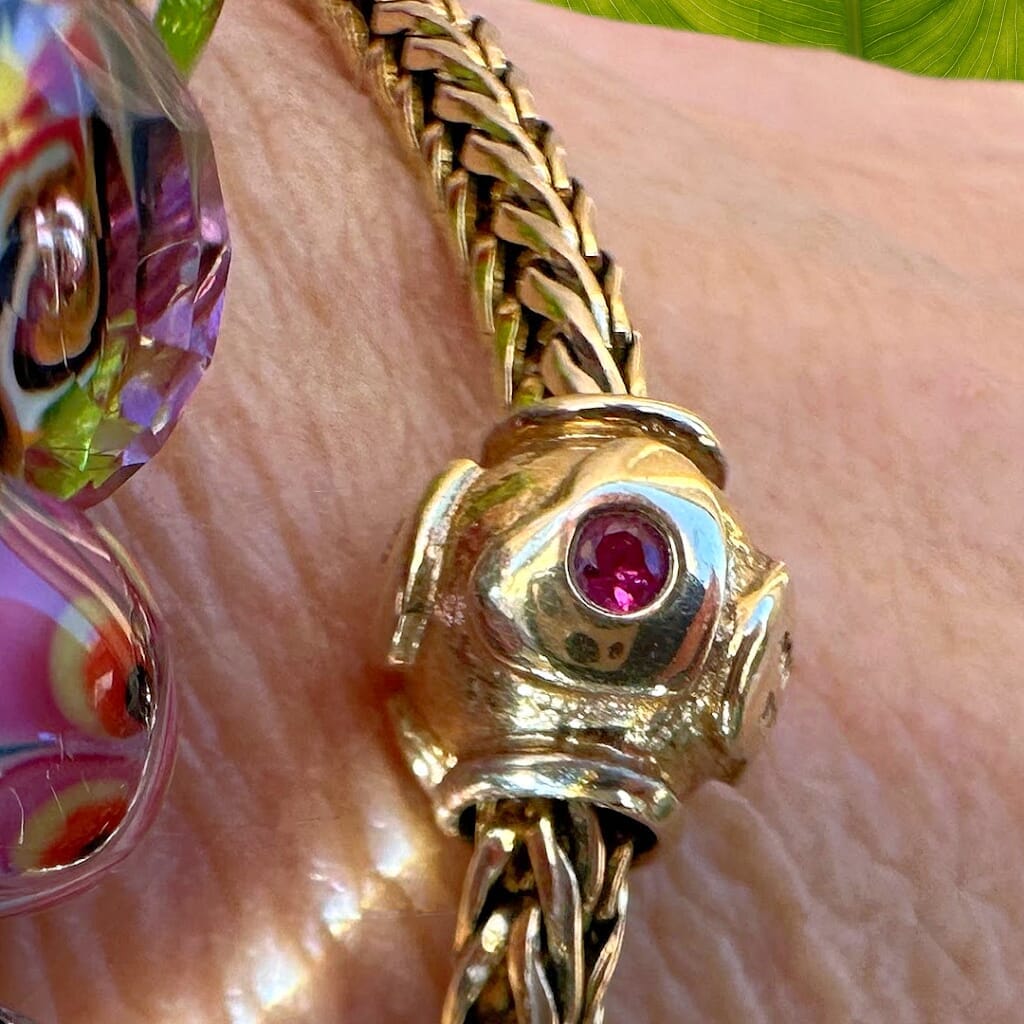 Limited Edition, 18-Karat Gold "heartbeat" Trollbead with four beautiful rubies, worn on an 18KT gold Trollbeads bracelet.