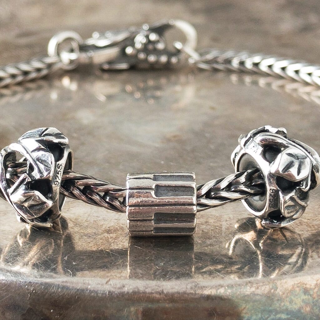 Trollbeads sterling silver AMADEUS bead, with piano keys around it, and shown on a sterling silver Trollbeads bracelet.