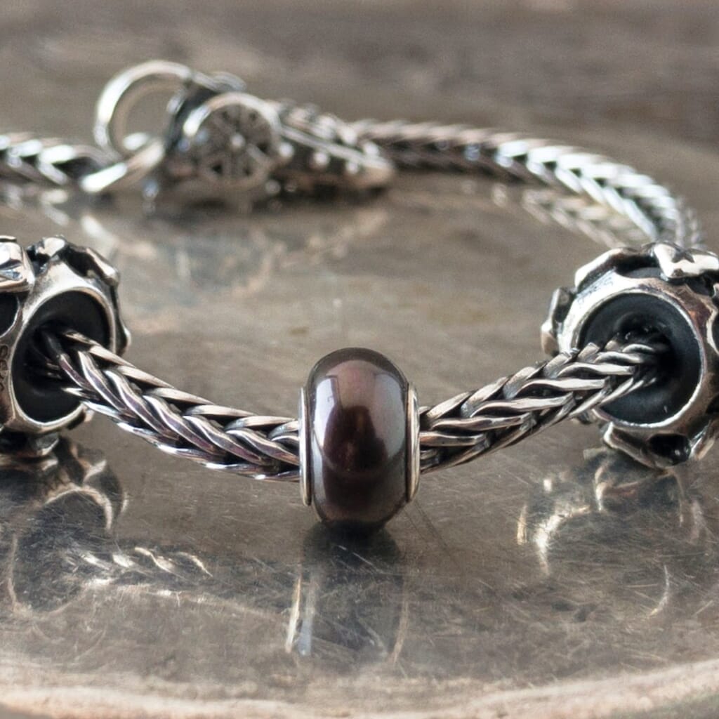 The three Black Pearl Trollbeads currently available at Suzie Q Studio have a sterling silver core and are smaller, more organically shaped than Trollbeads pearls available in later years makes them extra-unique and oh-so-precious! Visit Suzie Q Studio for new stock, never worn, collectible Rare & Retired Trollbeads.