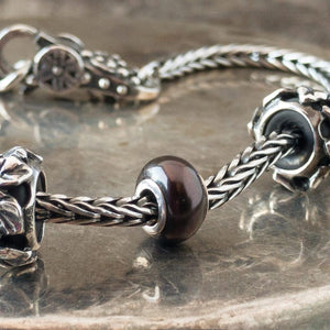The three Black Pearl Trollbeads currently available at Suzie Q Studio have a sterling silver core and are smaller, more organically shaped than Trollbeads pearls available in later years makes them extra-unique and oh-so-precious! Visit Suzie Q Studio for new stock, never worn, collectible Rare & Retired Trollbeads.