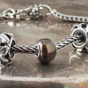 The three Black Pearl Trollbeads currently available at Suzie Q Studio have a sterling silver core and are smaller, more organically shaped than Trollbeads pearls available in later years makes them extra-unique and oh-so-precious! Visit Suzie Q Studio for new stock, never worn, collectible Rare & Retired Trollbeads.