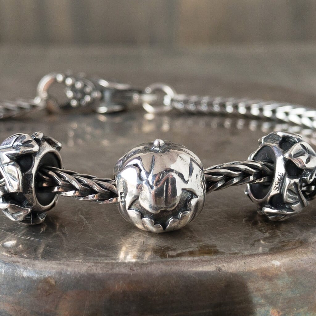 Trollbeads sterling silver PUMPKIN bead, with a carved bat shape, shown on a Trollbeads silver bracelet.