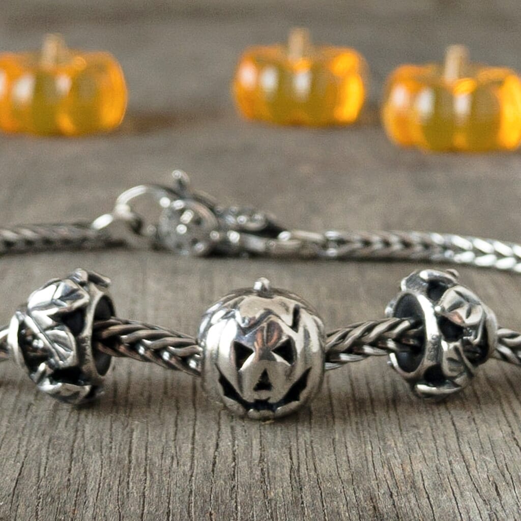 Trollbeads sterling silver PUMPKIN bead, with carved, smiling face, shown on a Trollbeads silver bracelet.