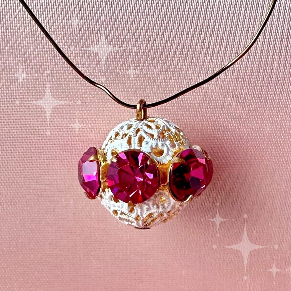 Vintage, fuchsia-coloured, Swarovski rhinestone bead ball on pink background.