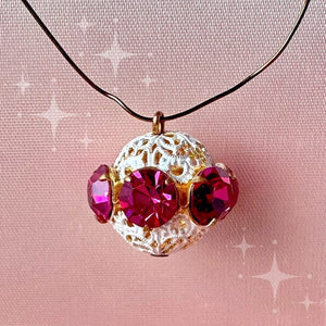 Vintage, fuchsia-coloured, Swarovski rhinestone bead ball on pink background.