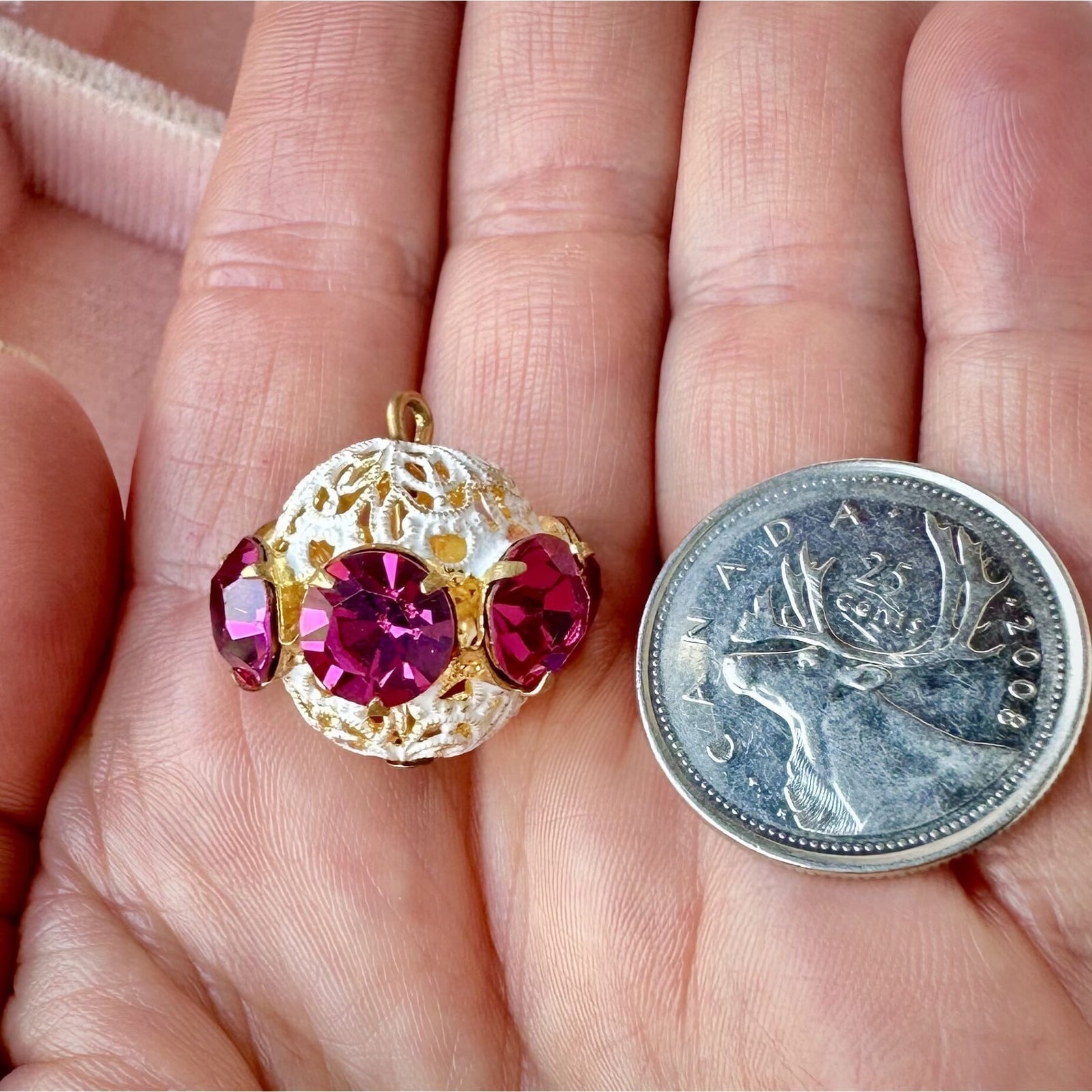 Vintage, fuchsia-coloured, Swarovski rhinestone bead ball on pink background.