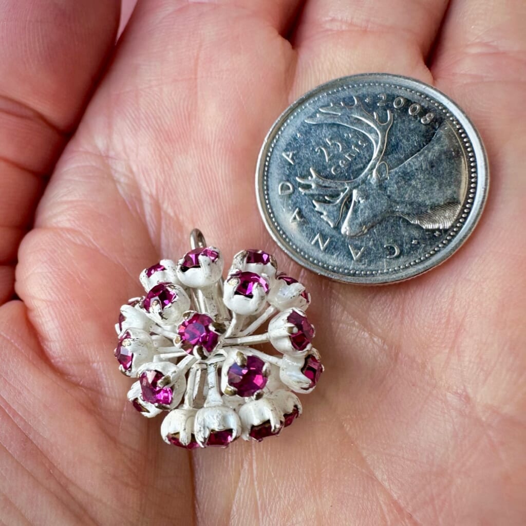 Vintage, Swarovski rhinestone bead ball, fuchsia-coloured stones and white metal, on a pink background.