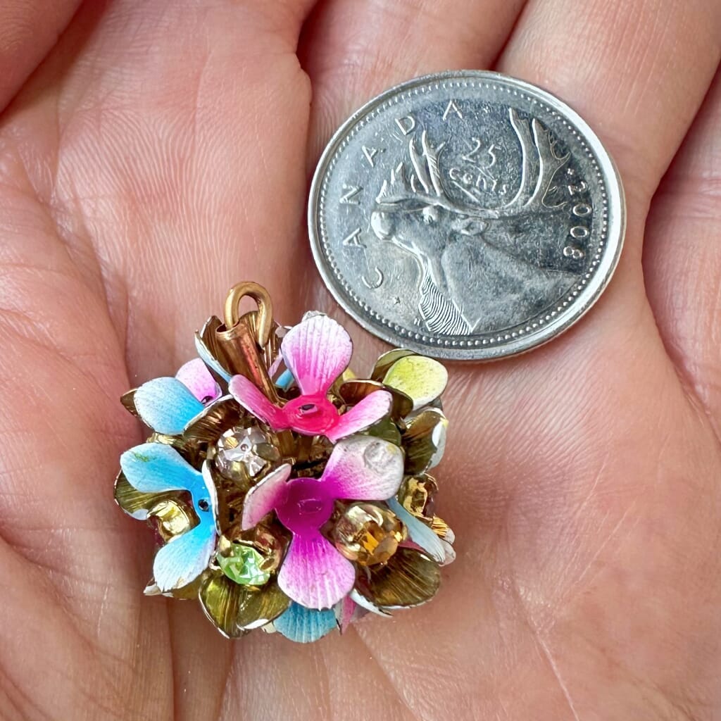 Vintage, Swarovski rhinestone, flower-style, bead ball charm with multi-coloured stones and flower petals, on a pink background.