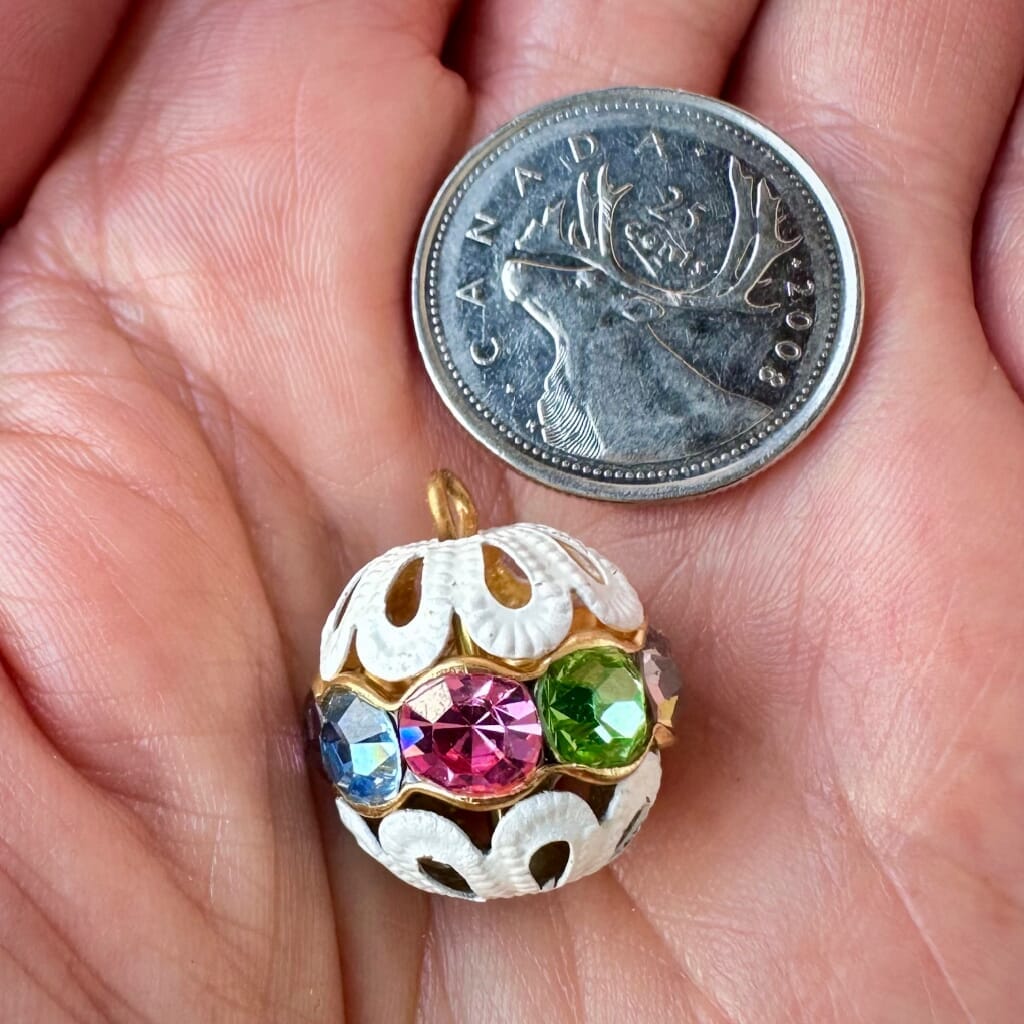 Vintage, multi-coloured, Swarovski rhinestone bead ball  charm on a pink background.
