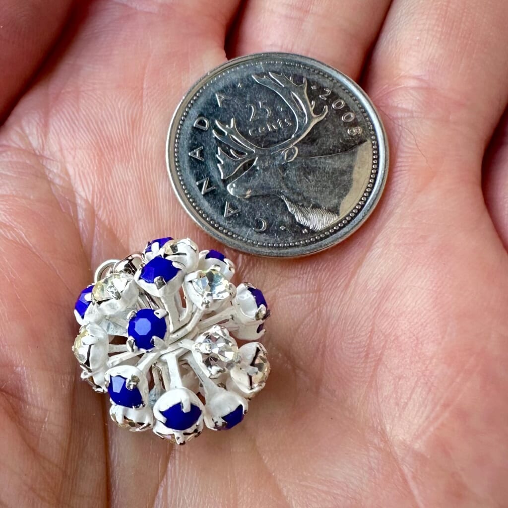Vintage, Swarovski rhinestone bead ball, opaque blue and crystal-coloured stones and white metal, on a pink background.