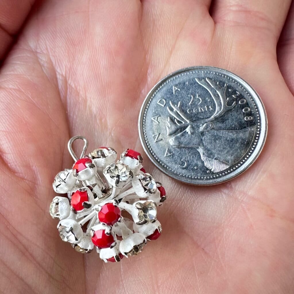 Vintage, Swarovski rhinestone bead ball, opaque red and crystal-coloured stones, and white metal, on a pink background.