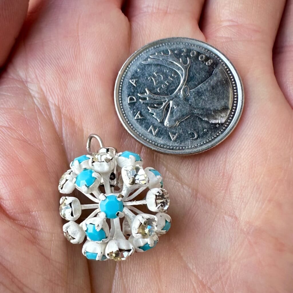 Vintage, Swarovski rhinestone bead ball, opaque turquoise and crystal-coloured stones and white metal, on a pink background.