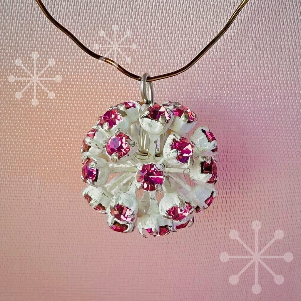 Vintage, Swarovski rhinestone bead ball, fuchsia-coloured stones and white metal, on a pink background.