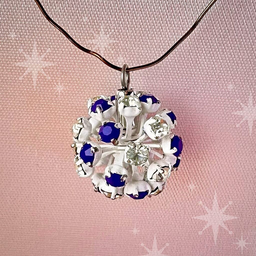 Vintage, Swarovski rhinestone bead ball, opaque blue and crystal-coloured stones and white metal, on a pink background.